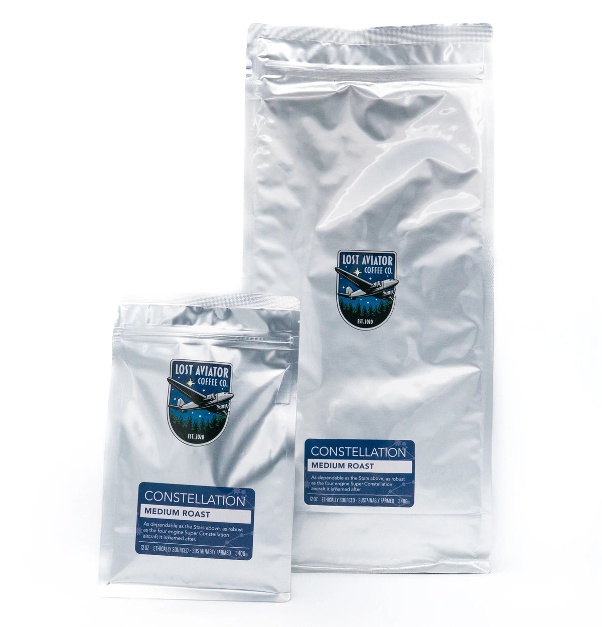 Two silver foil bags of Lost Aviator Coffee Co. Constellation Medium Roast, one small and one large, displayed on a clean white background.
