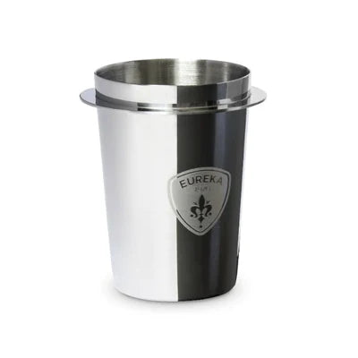 A stainless steel cup with a silver design and a shield emblem featuring a fleur-de-lis and the word 'EUREKA'.
