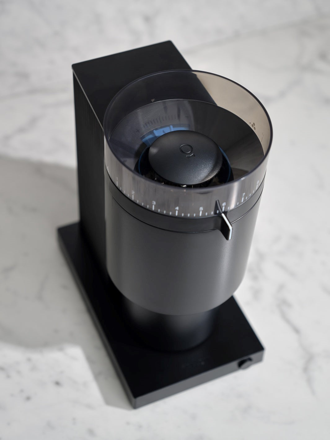 Black coffee grinder on a marble surface