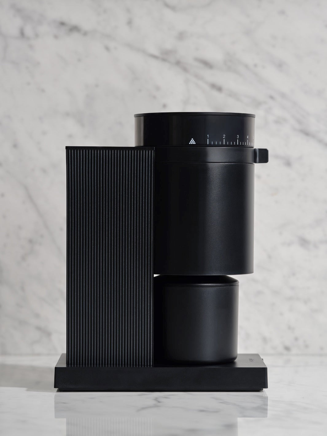 Black all-purpose coffee grinder on a marble surface