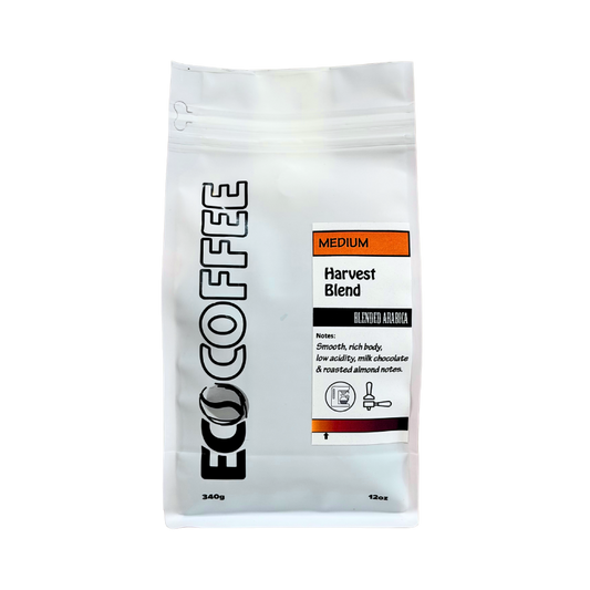 A 12oz stand-up pouch of Eco Coffee Medium Harvest Blend Blended Arabica coffee, shown on a plain white background.