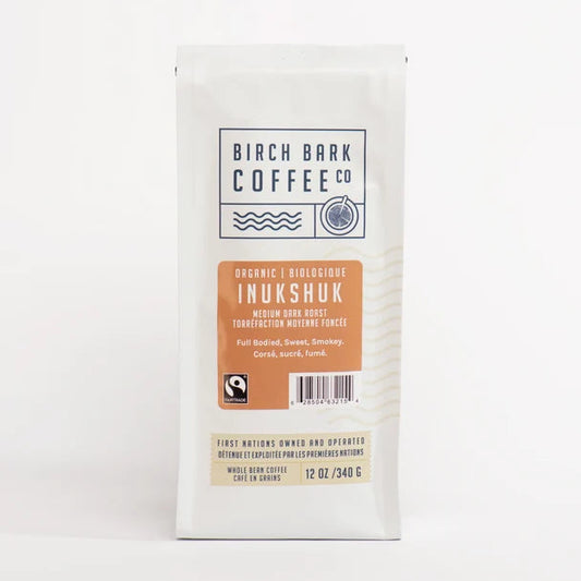 A white bag of Birch Bark Coffee Co. Organic Inukshuk medium dark roast coffee, shown against a plain white background.