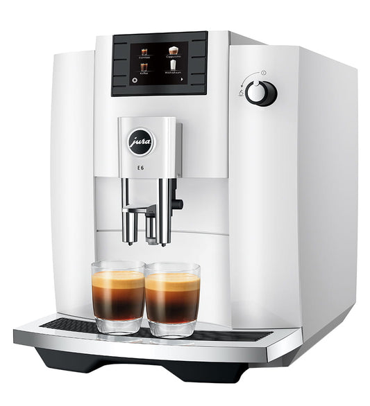 White coffee machine turned to the side with two glasses of coffee on a white background
