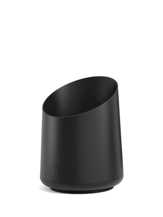 Black scale dosing cup on a white background