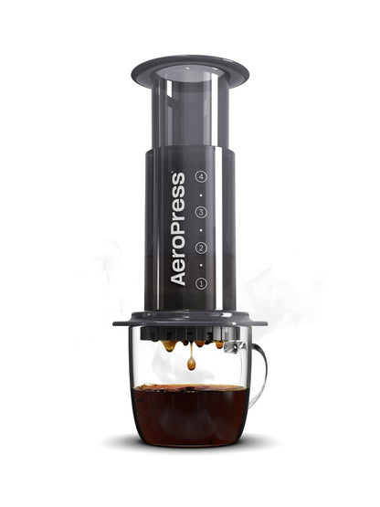 Aeropress coffee maker with a cup of coffee on a white background