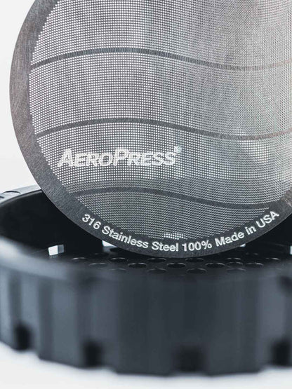 Aeropress coffee maker filter with 'Aeropress' branding on a white background