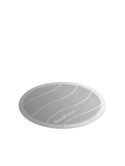 A circular Aeropress Filter shown on a plain white background. The filter features a silver-gray mesh screen with wavy gray lines and the Aeropress brand name printed on it.