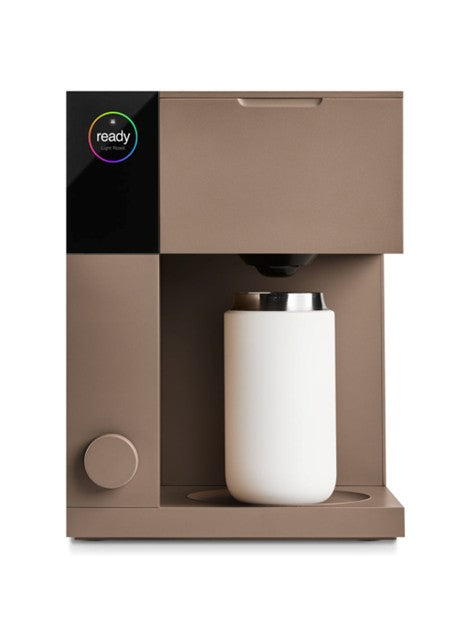 Fellow Aiden Brown coffee machine with a white mug on a white background