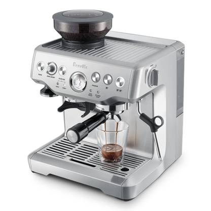Breville espresso machine with a glass of coffee on a white background Top angle
