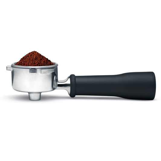 Coffee portafilter with black handle and, filled with coffee grounds on a white background