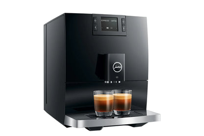 Black coffee machine with two glasses of coffee on a white background