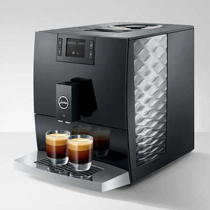 Modern coffee machine with two glasses of coffee on a white background