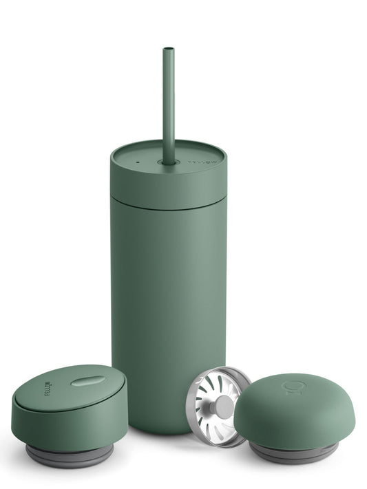 Green tumbler with various lids and a straw on a white background