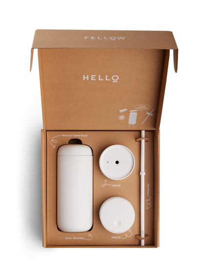 Fellow Carter kit with white mug, lids, and spout in a brown box on a white background