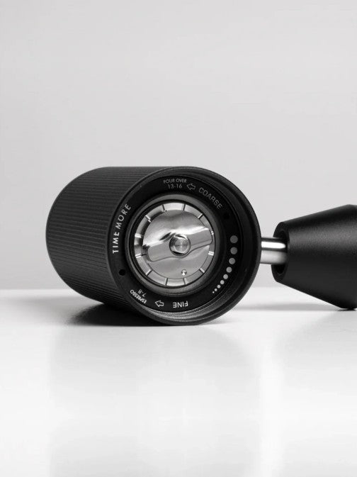 Black and silver coffee grinder adjustment dial on a white background