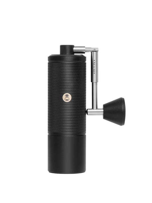 Black manual coffee grinder with a silver handle on a white background