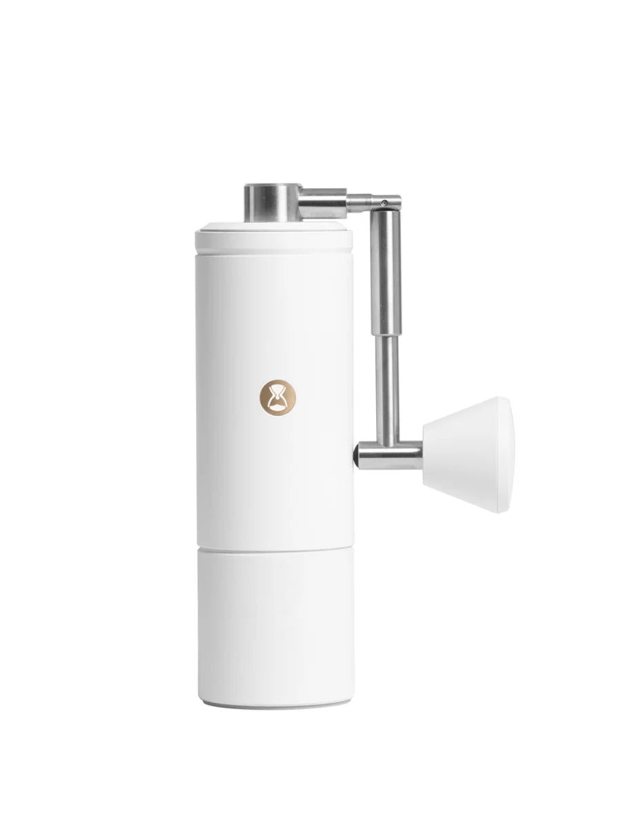 White coffee grinder with metallic accents on a white background