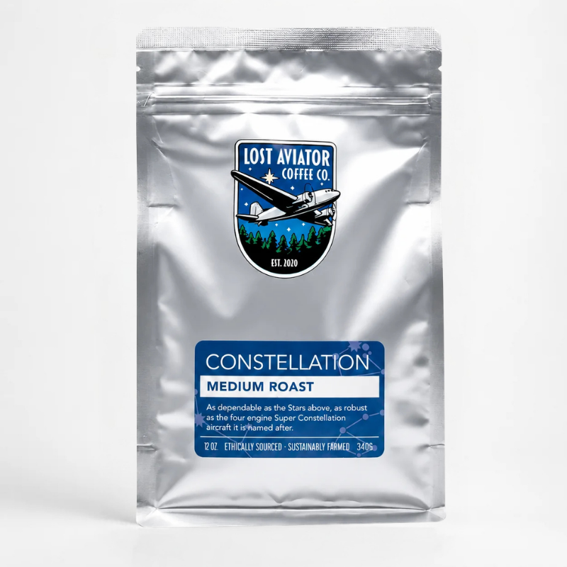 A silver aluminum coffee bag with a blue and white label reading 'Constellation Medium Roast' and a Lost Aviator Coffee Co. logo, photographed on a light gray background.