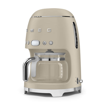 Beige coffee machine with glass carafe on a white background