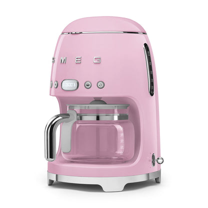 Pink coffee machine with glass carafe on a white background