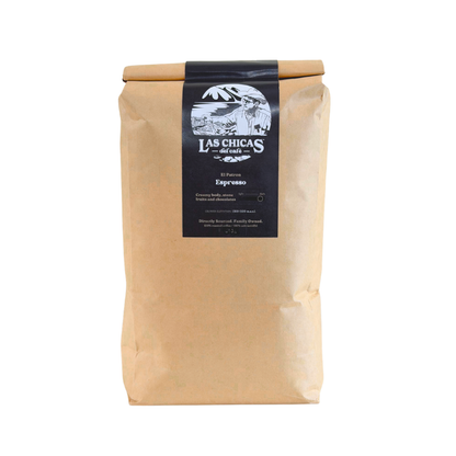 A brown kraft paper bag of Las Chicas Coffee Roasted Espresso, featuring a black label with white text and illustration, set against a plain white background.