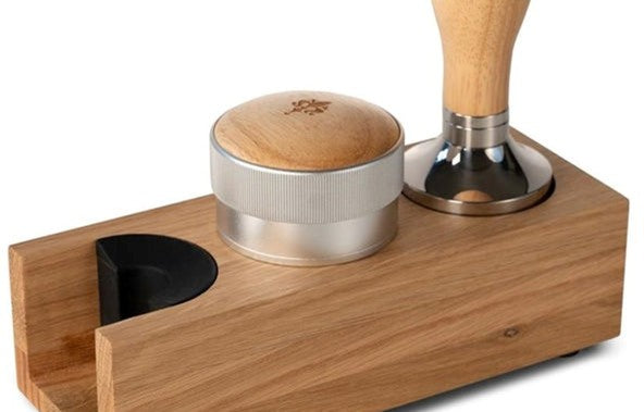 Wooden coffee tamping device with metal distribution tool and wooden handle tamper on a white background