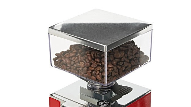 Coffee grinder with coffee beans inside on a white background