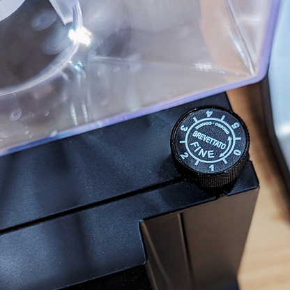 Eureka Coffee grinder adjustment knob on a blurred background