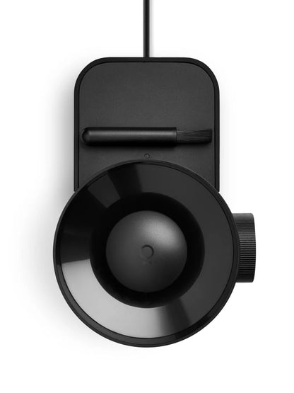Black cylindrical device with a circular component on a white background