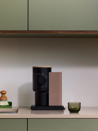 Modern coffee grinder on a kitchen counter with a minimalist design.