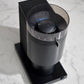Black coffee grinder on a marble surface