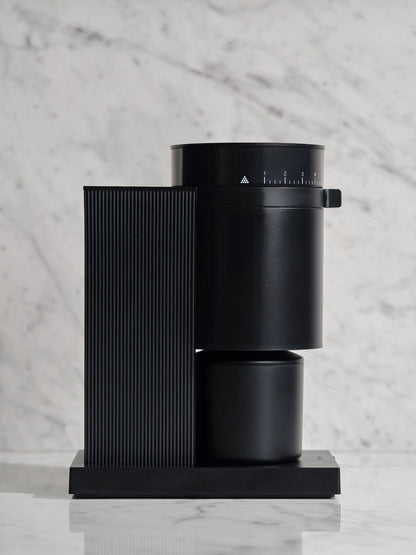 Black all-purpose coffee grinder on a marble surface
