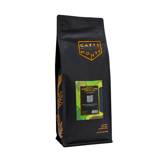 Black Bag of Caffe Monte's Guatemala Light Roast Coffee. Gold text on a green label, with gold accents.
