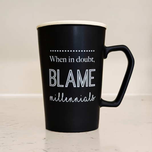 Black mug with humorous text on a light background