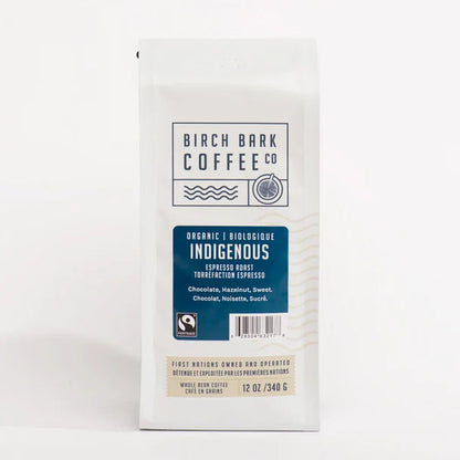 A 12 oz bag of Birch Bark Coffee Co. Indigenous Organic Espresso Roast coffee, shown in its white packaging with a blue label on a clean white background.