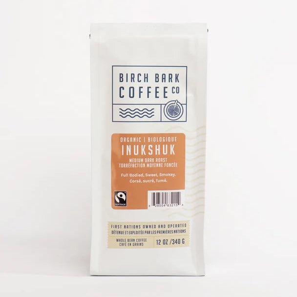 A white bag of Birch Bark Coffee Co. Organic Inukshuk medium dark roast coffee, shown against a plain white background.
