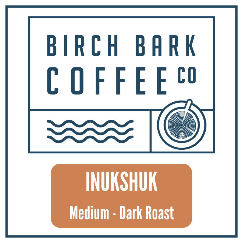 A square coffee label design for Birch Bark Coffee Co, featuring the brand name in dark blue text above a stylized wavy line graphic and a coffee cup icon. Below the main logo is a tan rounded rectangle with white text reading 'INUKSHUK' and 'Medium - Dark Roast'.
