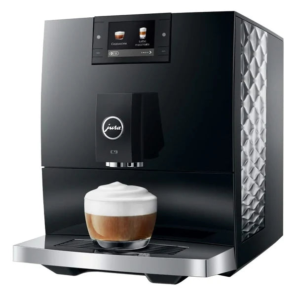 Black coffee machine with a glass of cappuccino on a white background