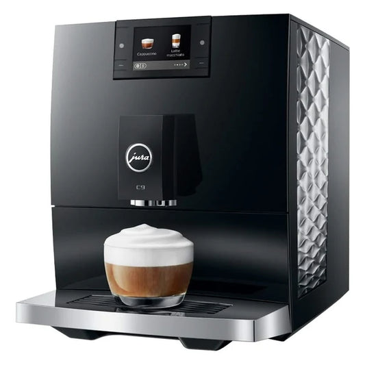 Black coffee machine with a glass of cappuccino on a white background