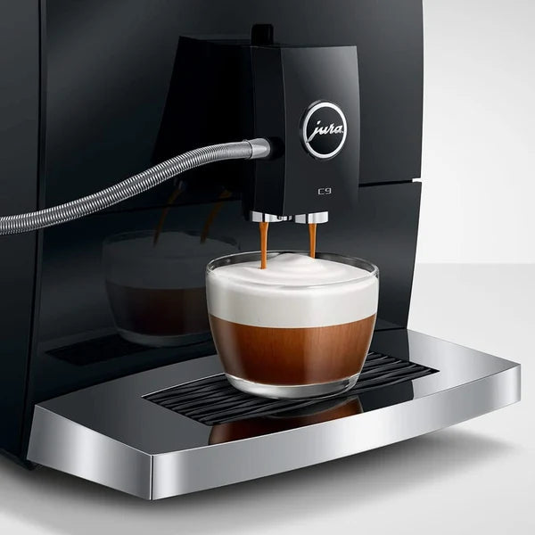 Jura coffee machine dispensing a cup of coffee with a white background
