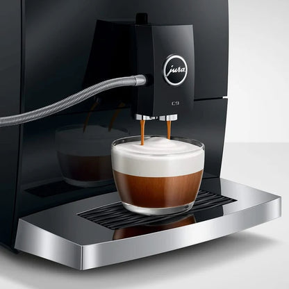 Jura coffee machine dispensing a cup of coffee with a white background