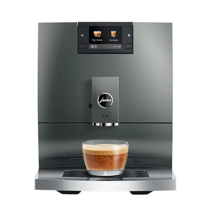 Modern coffee machine with a glass of coffee on a white background
