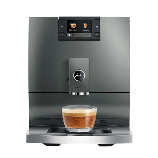 Modern coffee machine with a glass of coffee on a white background