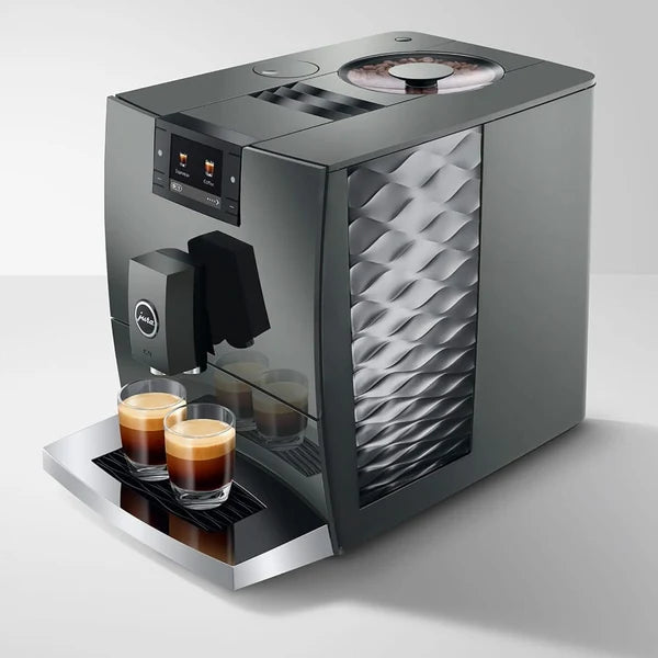 Modern coffee machine with two glasses of coffee on a white background