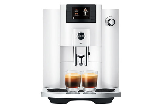 White coffee machine with two cups of coffee on a white background