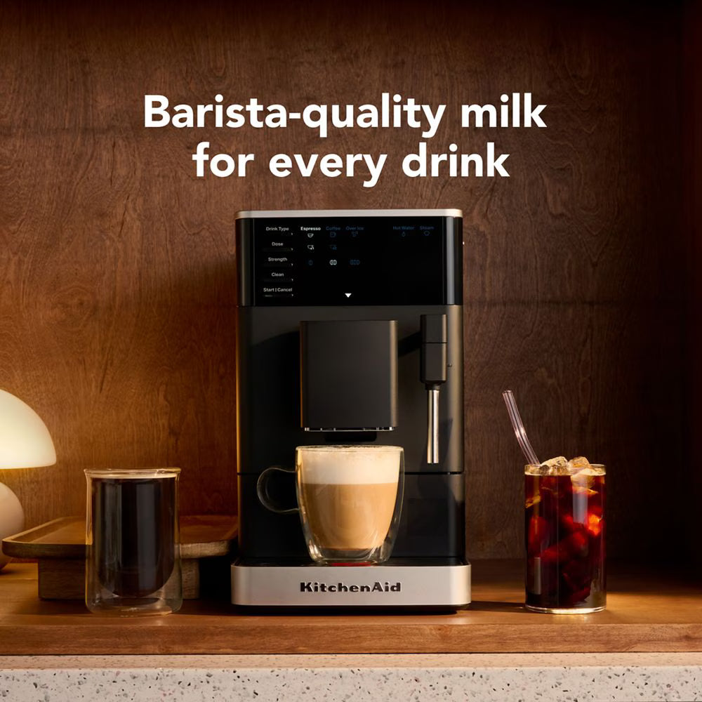 KitchenAid coffee machine with a cup of coffee and a glass of iced tea on a wooden surface.