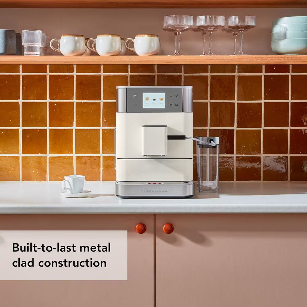 Coffee machine on a kitchen counter with tiled wall and shelves in the background