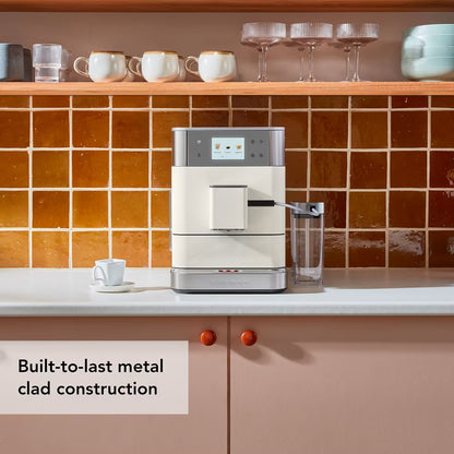 Coffee machine on a kitchen counter with tiled wall and shelves in the background