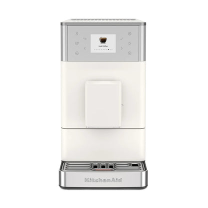 A KitchenAid coffee machine in off-white and silver, featuring a digital touch screen and drip tray, shown against a plain white background.