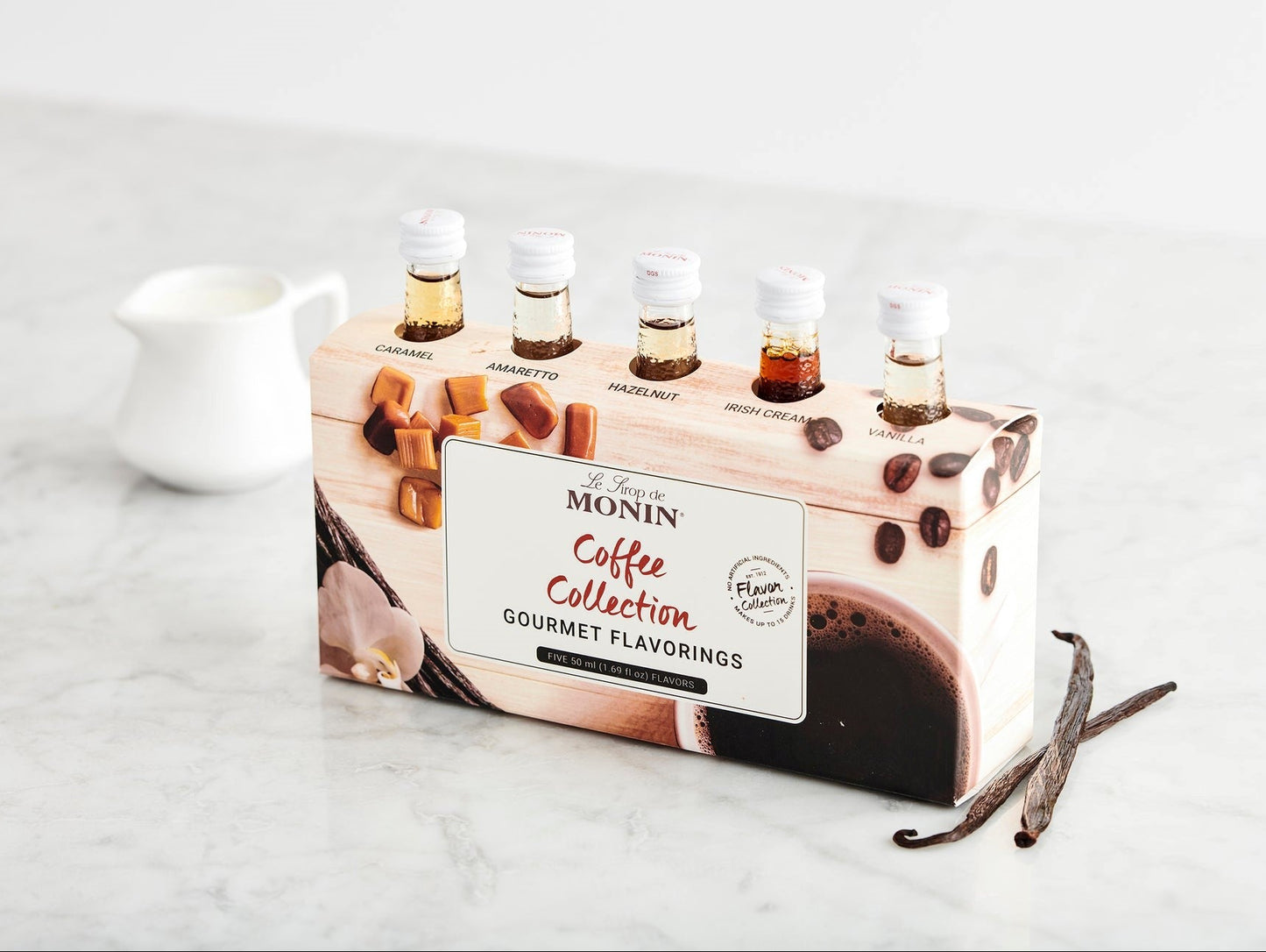 Monin Coffee Collection packaging with coffee bottles on a marble surface